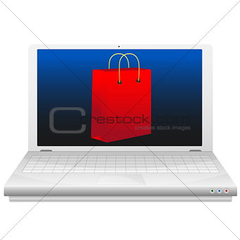 On line shopping concept. Red shopping bag at laptop screen.