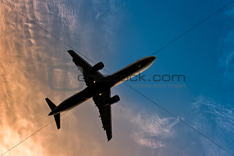 Airliner silhouette against the blue sky