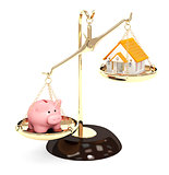 Piggy bank and house on bowls of scales