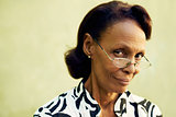 Portrait of confident old black lady with eyeglasses smiling