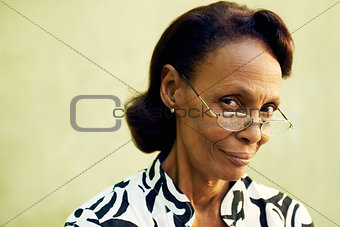Portrait of confident old black lady with eyeglasses smiling