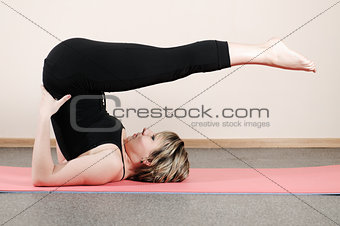 young woman doing yoga exercises