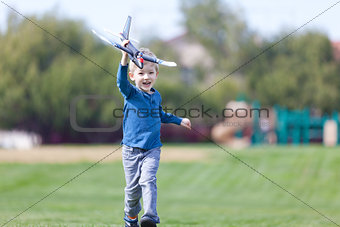 child playing with a plane