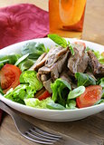 warm salad with grilled meat and vegetables
