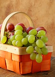 Red and green grapes in a wicker basket