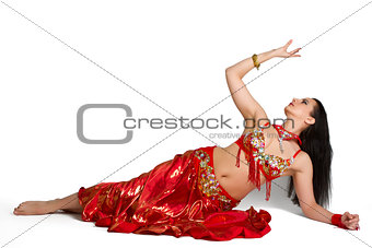 Beautiful young girl in a red suit oriental dance in motion isol