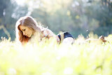 Beautiful Young Woman lying on grass reading