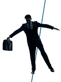 Businessman  tightrope walker silhouette