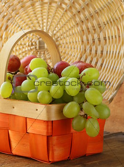 Red and green grapes in a wicker basket