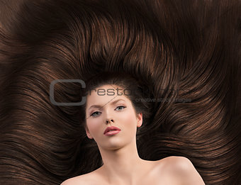 girl with long brown hair and nude shoulders 