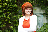 Portrait of a young beautiful girl in an orange knitted beret