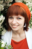 Portrait of a young beautiful girl in an orange knitted beret