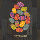 Easter eggs. Composed in one egg shape on wooden planks backgrou