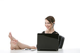 Business woman with headset with feet up on desk