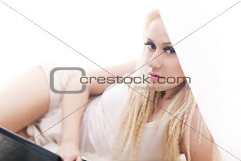 Blonde girl lying in bed