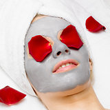 woman with facial mask and rose