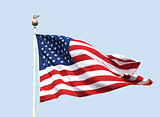 The American flag flies on a sunny day against a clear blue sky.