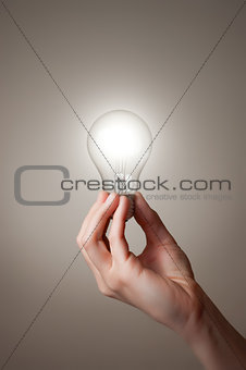 Hand with light bulb
