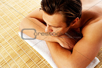 Man relaxing in a spa resort on mat