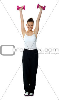 Young girl exercising with dumbbells