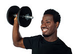 Powerful muscular young man lifting weights