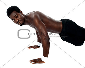 Handsome fit shirtless man doing pushups