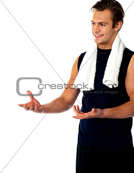 Male trainer posing with open hands and looking away