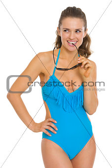 Portrait of thoughtful young woman in swimsuit looking on copy s