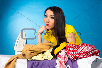 Houseworks, woman with pile of clothes for ironing