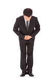 full length of asian businessman with bow and kindly gesture