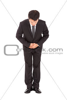 full length of asian businessman with bow and kindly gesture