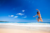 Woman jumping on the beach