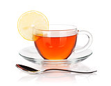 Glass cup of black tea with lemon slice and spoon