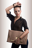 fashion brunette with bag and hand on the head