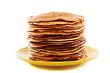 Stack of pancakes on a yellow plate.