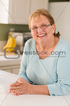 Portrait of Beautiful Senior Adult Woman in Kitchen