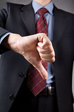 Businessman showing thumbs down