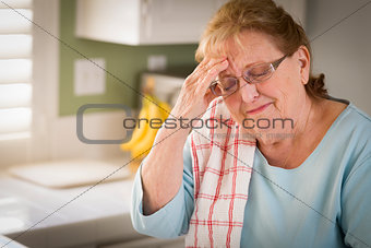 Sad Crying Senior Adult Woman At Kitchen Sink