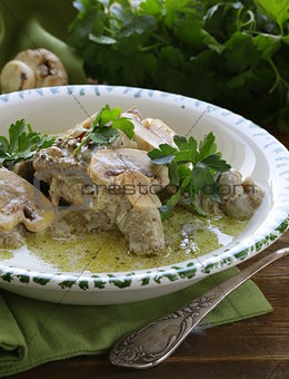 stew chicken in a creamy sauce with mushrooms