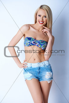 Blond sexy woman in short jeans and bikini bra