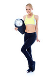 Full body of blond sporty woman holding scale