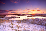 dramatic sunrise over frozen lake