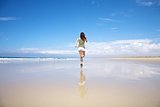 back sportswoman running on seaside