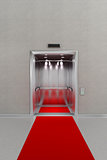 Open elevator with red carpet