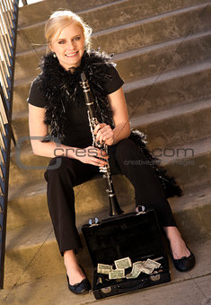 Female Street Performer Sits on Steps Clarinet Case With Tips