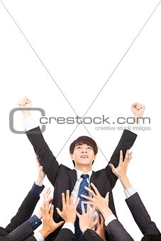young businessman with success gesture and group of support hand