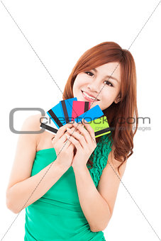 happy young woman holding credit cards