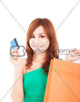 young woman holding credit card with shopping bag