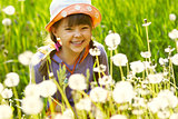 smiling girl in a field of dandelions