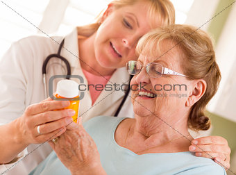 Female Doctor or Nurse Explaining Prescription to Senior Adult W